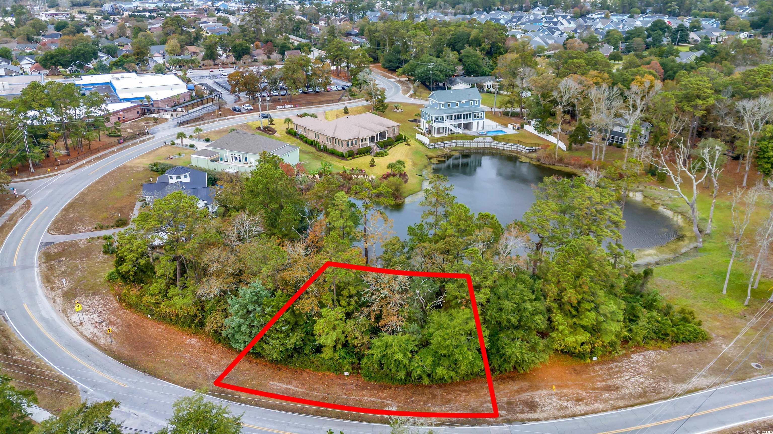 Birds eye view of property with a water view