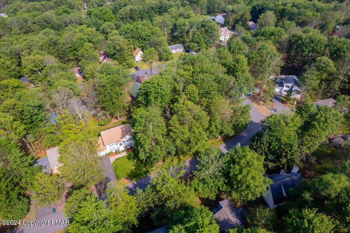 an aerial view of residential house with swimming pool and outdoor space