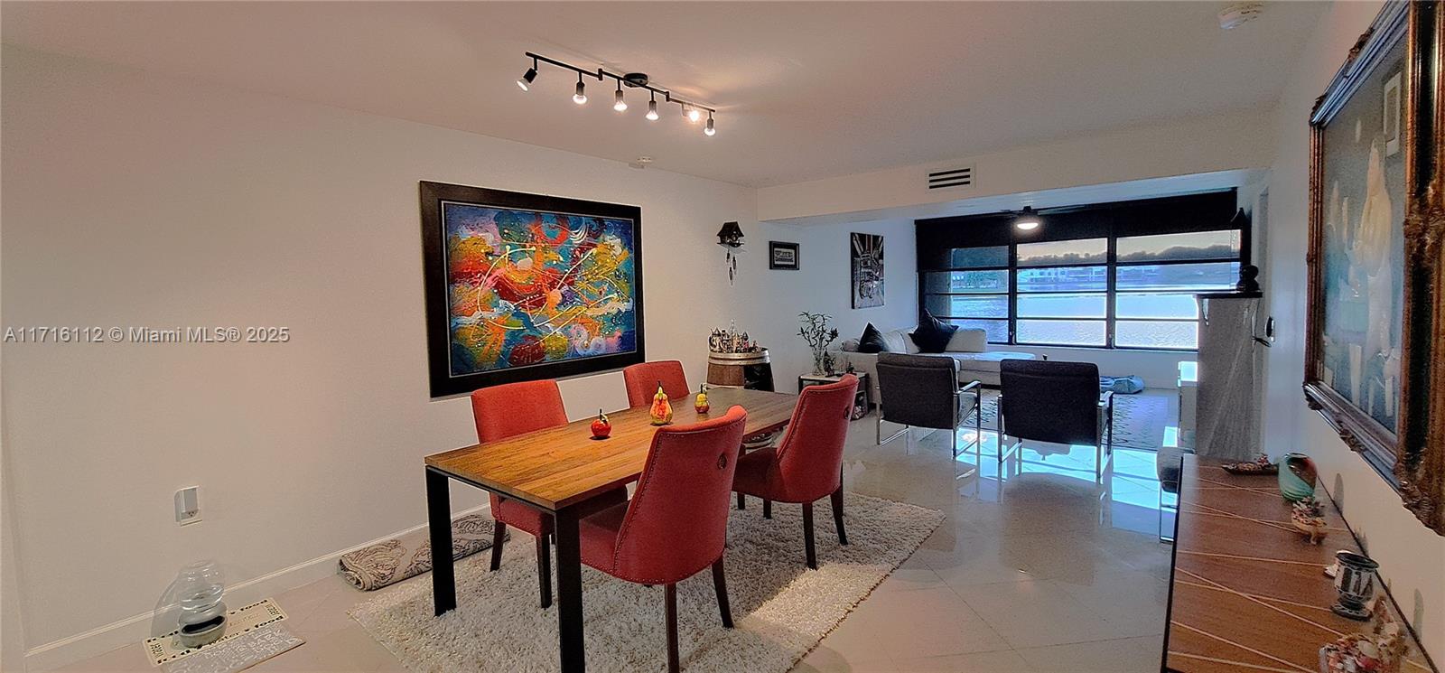 a living room with furniture a rug and a large window