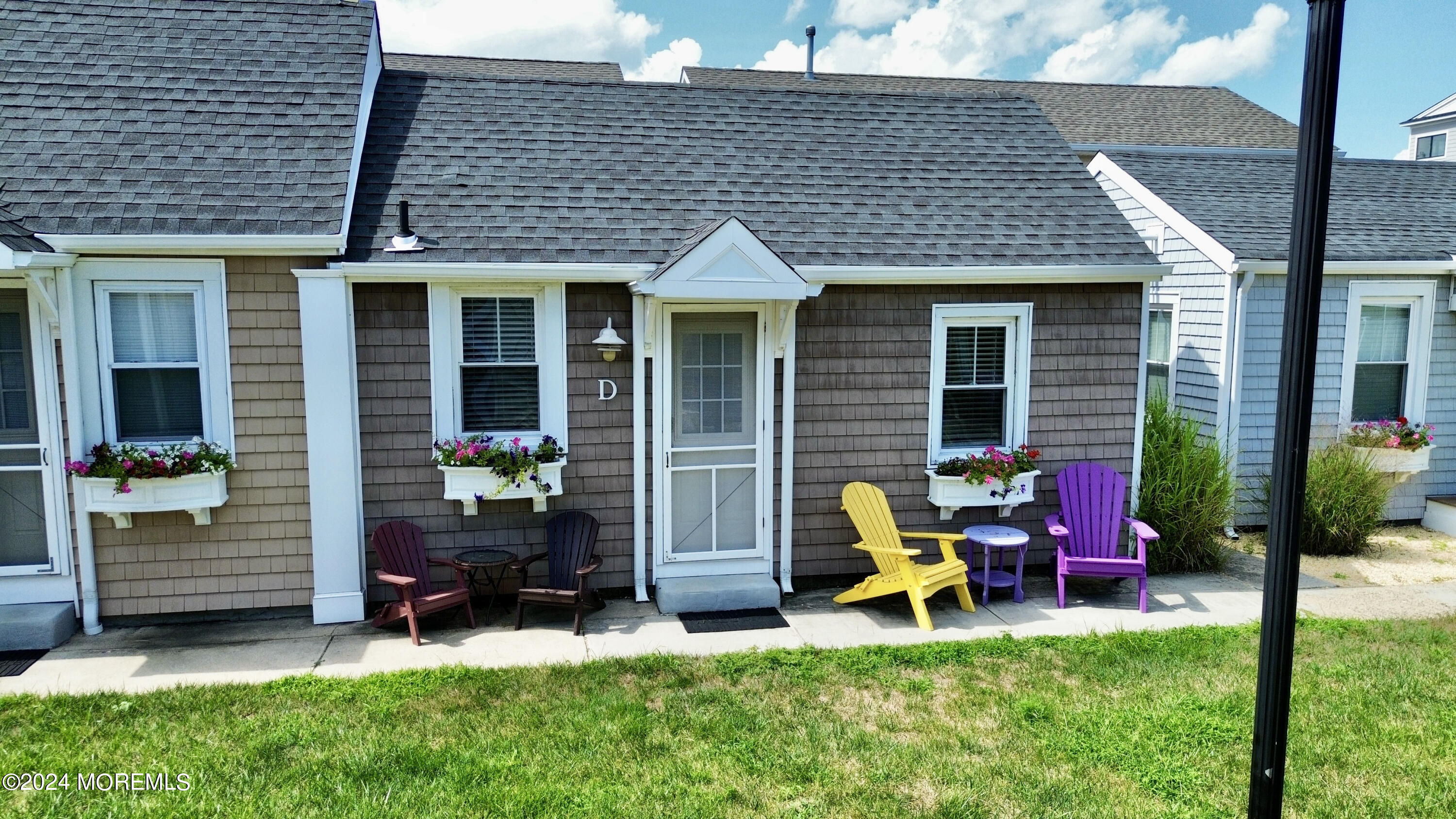 a view of backyard of house with seating space