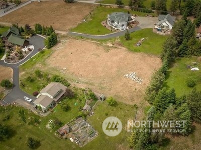 an aerial view of a house with yard swimming pool and outdoor seating