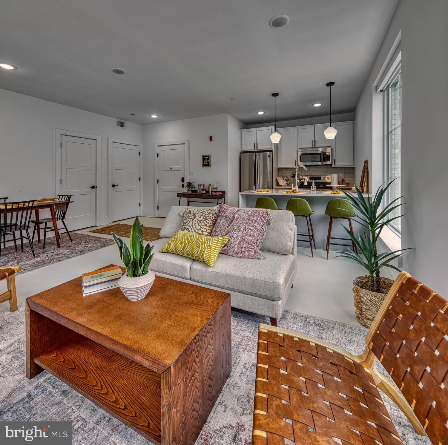 a living room with furniture kitchen view and a table