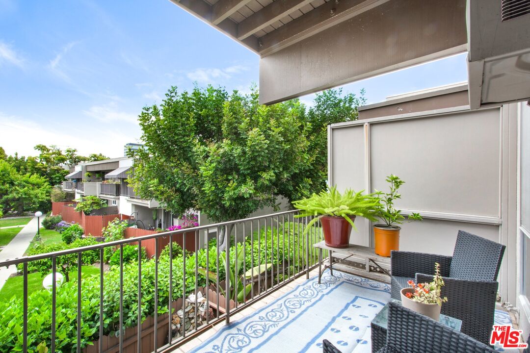 a view of a chairs and table in a balcony