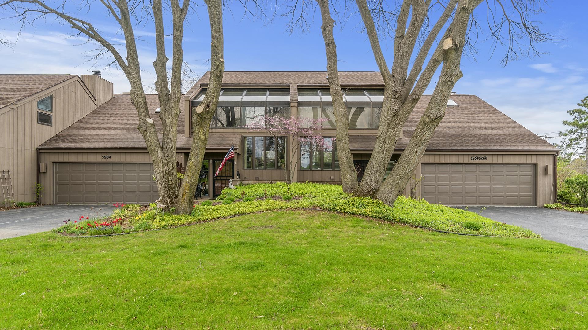 a backyard of a house with table and chairs