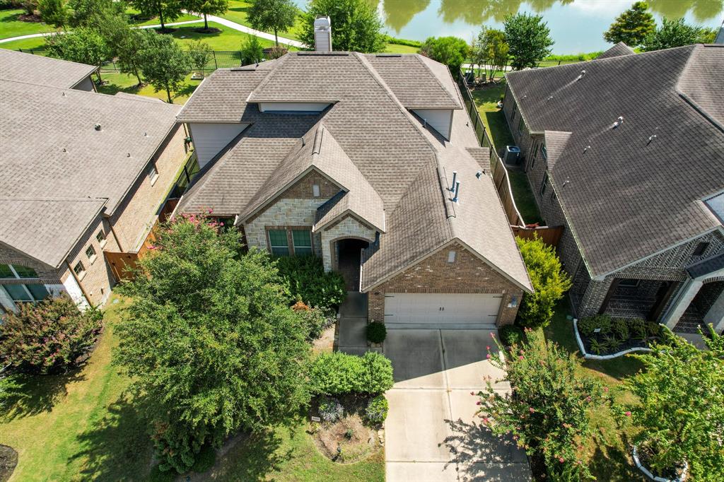 an aerial view of a house with a yard