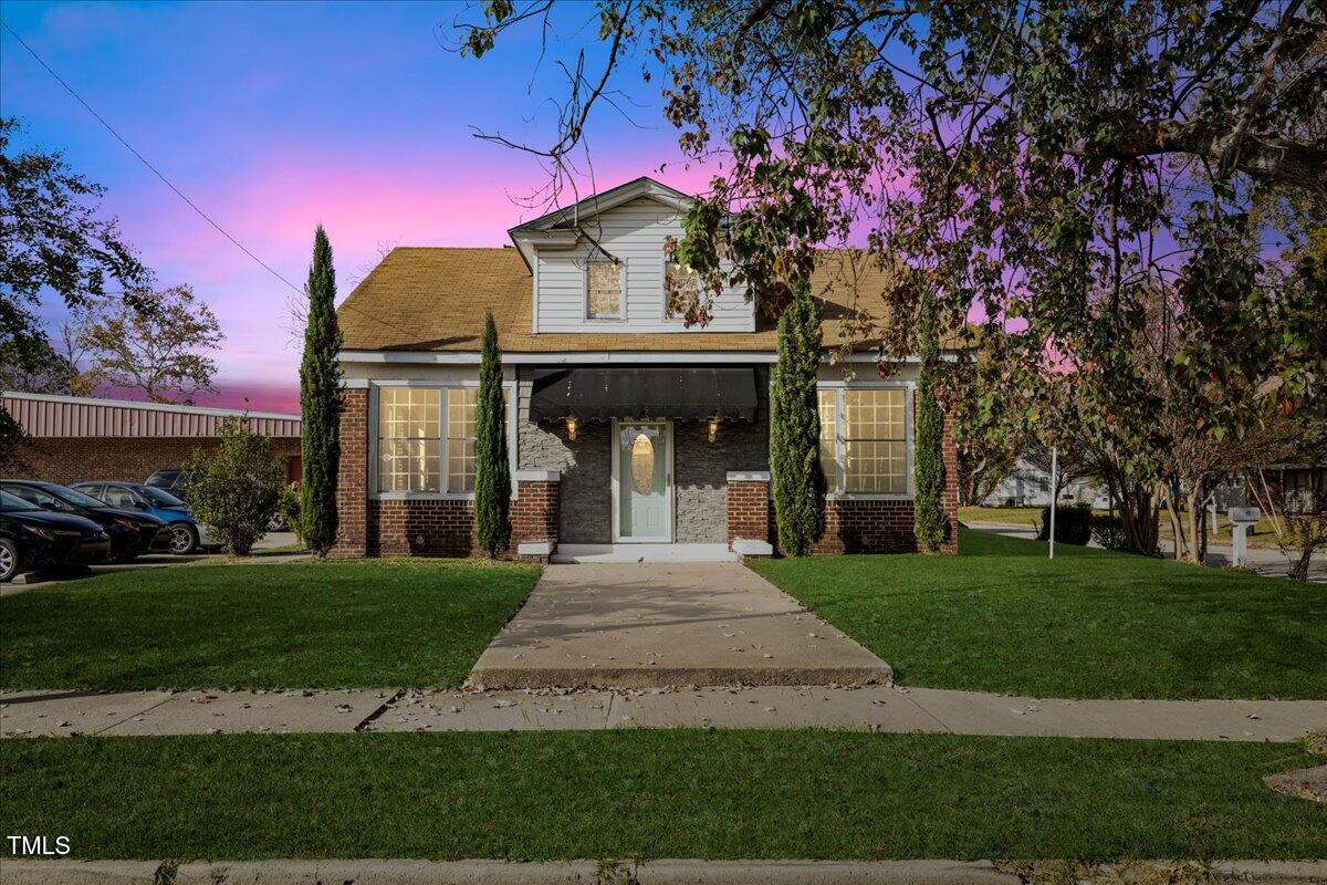 a front view of a house with garden