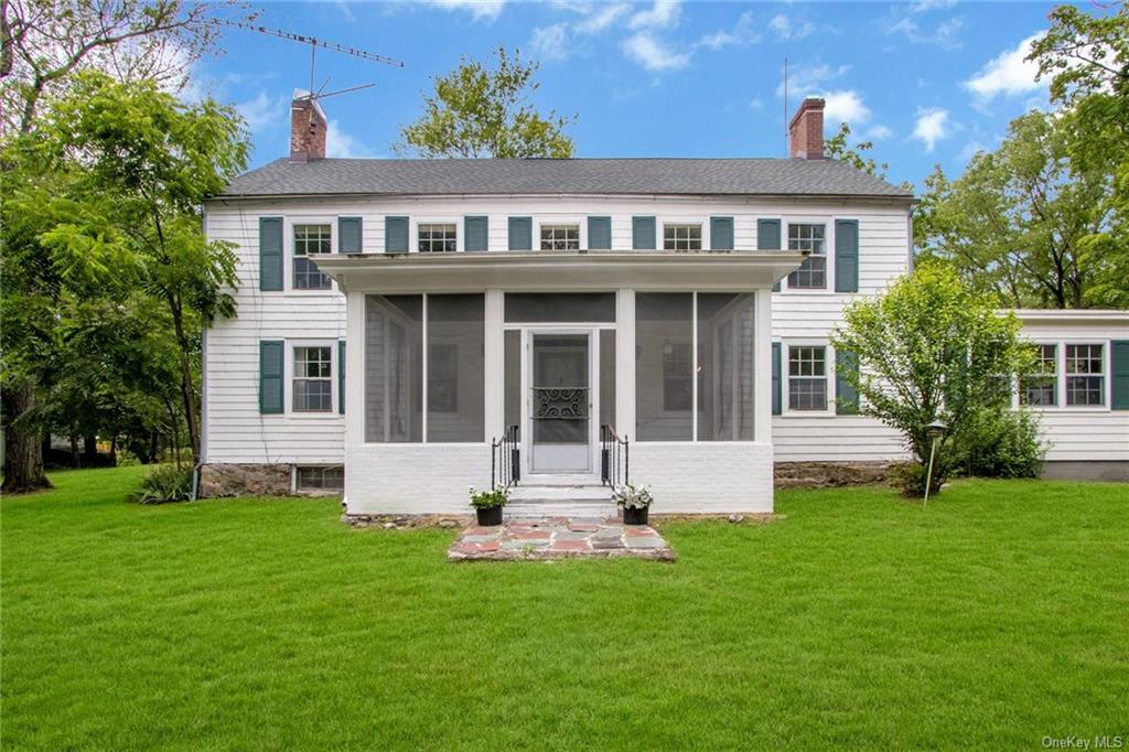 a front view of a house with a garden and yard