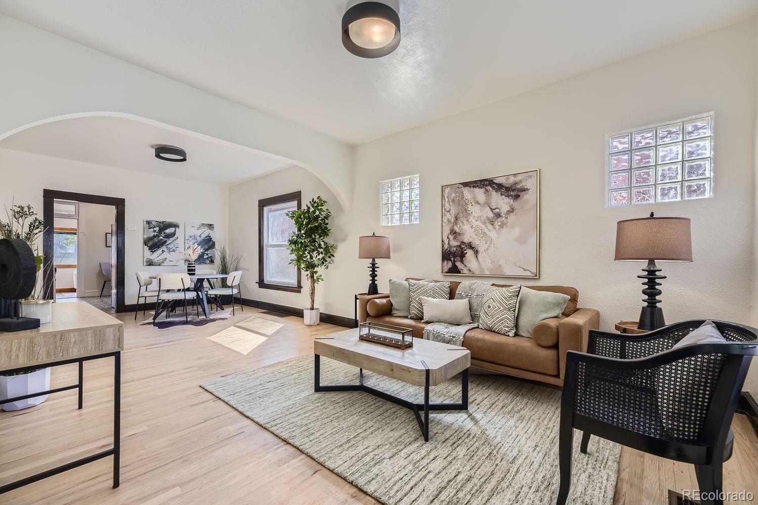 a living room with furniture rug and window