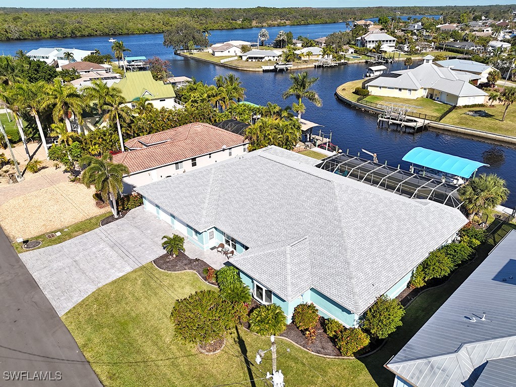 an aerial view of a swimming pool with outdoor seating