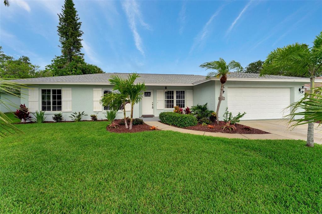 a front view of house with yard and outdoor seating