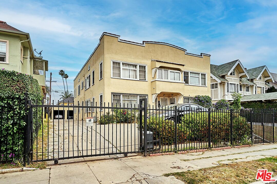 a front view of a house with iron fence