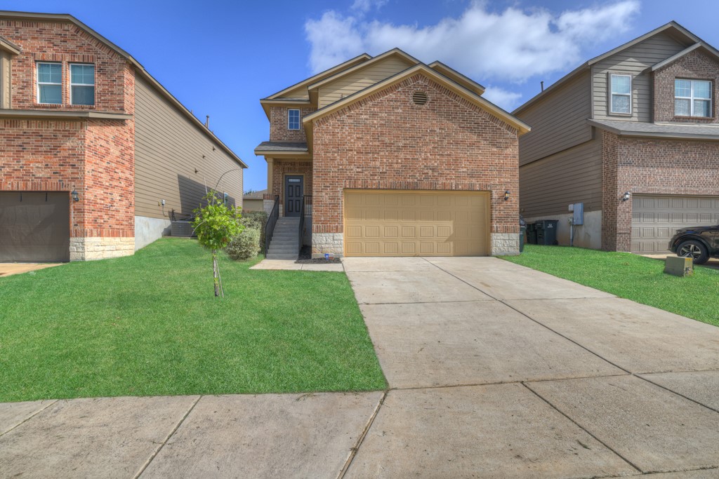 a front view of a house with a yard and garage