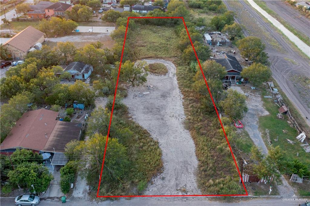 an aerial view of a house with a yard and lake view