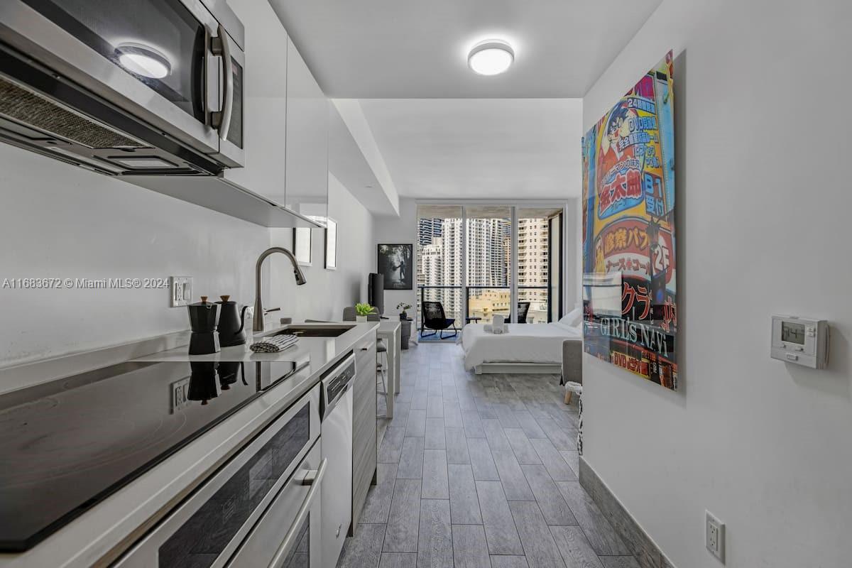 a kitchen with stainless steel appliances a sink and cabinets