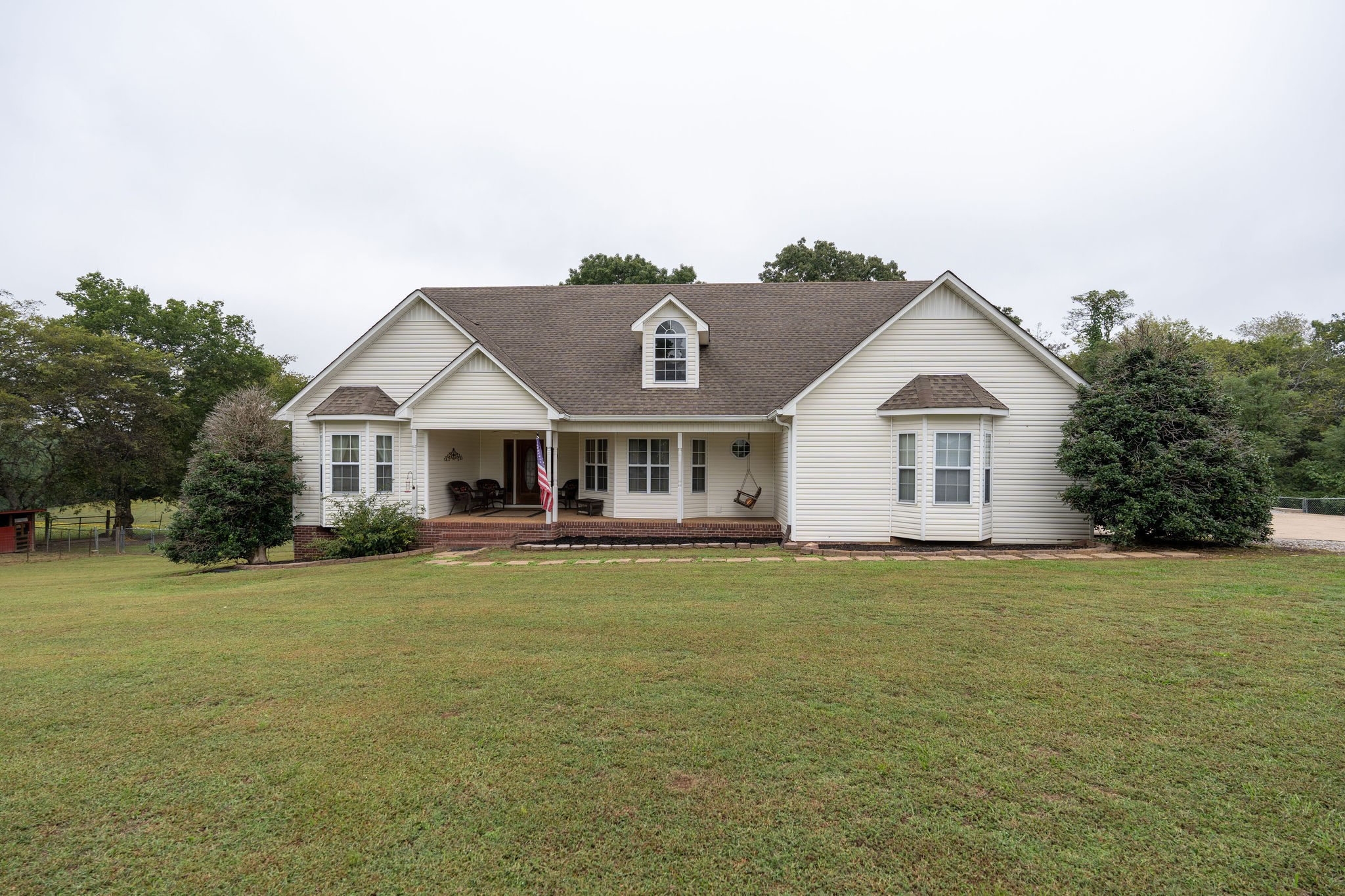 a front view of a house with a garden