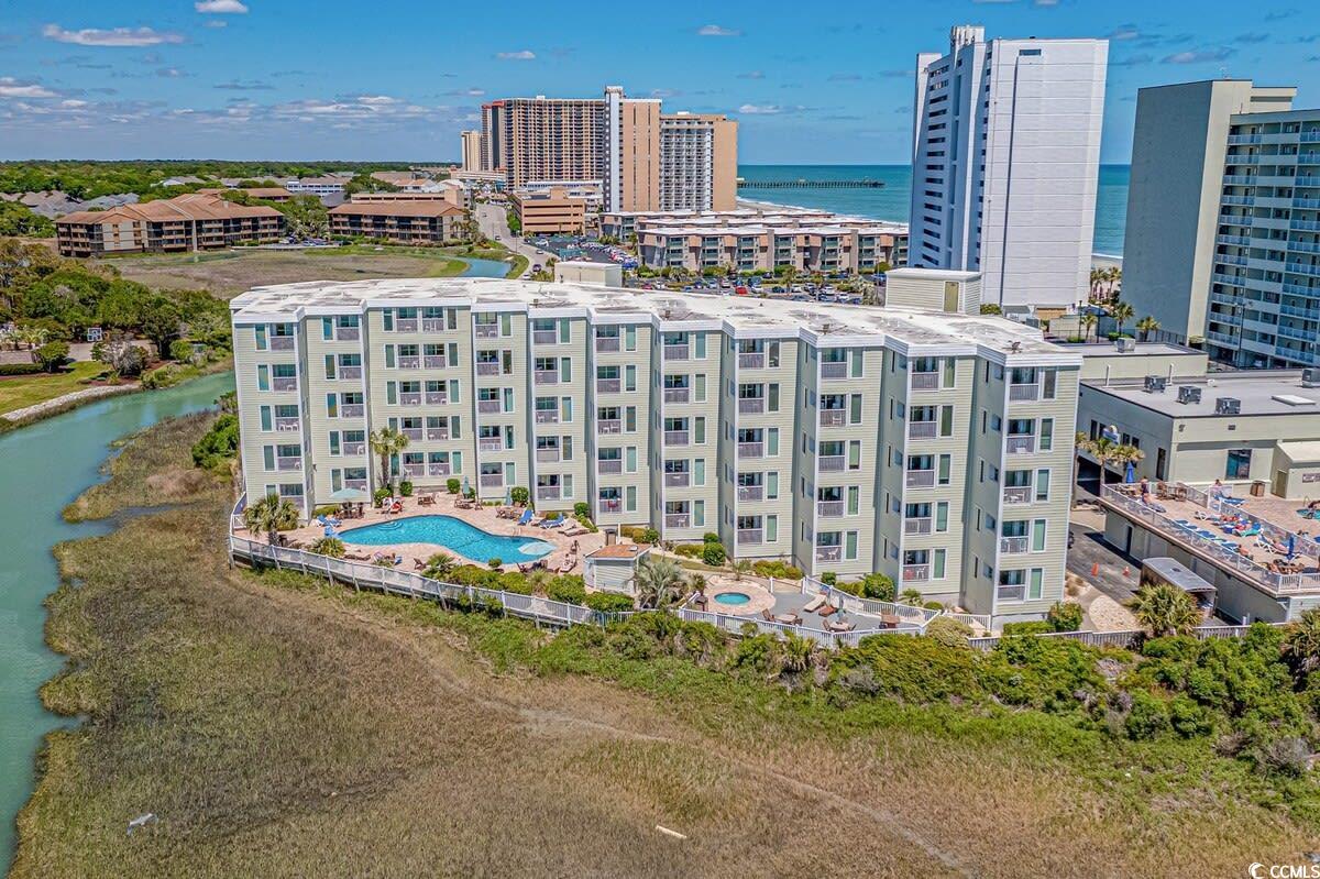 Birds eye view of property with a water view