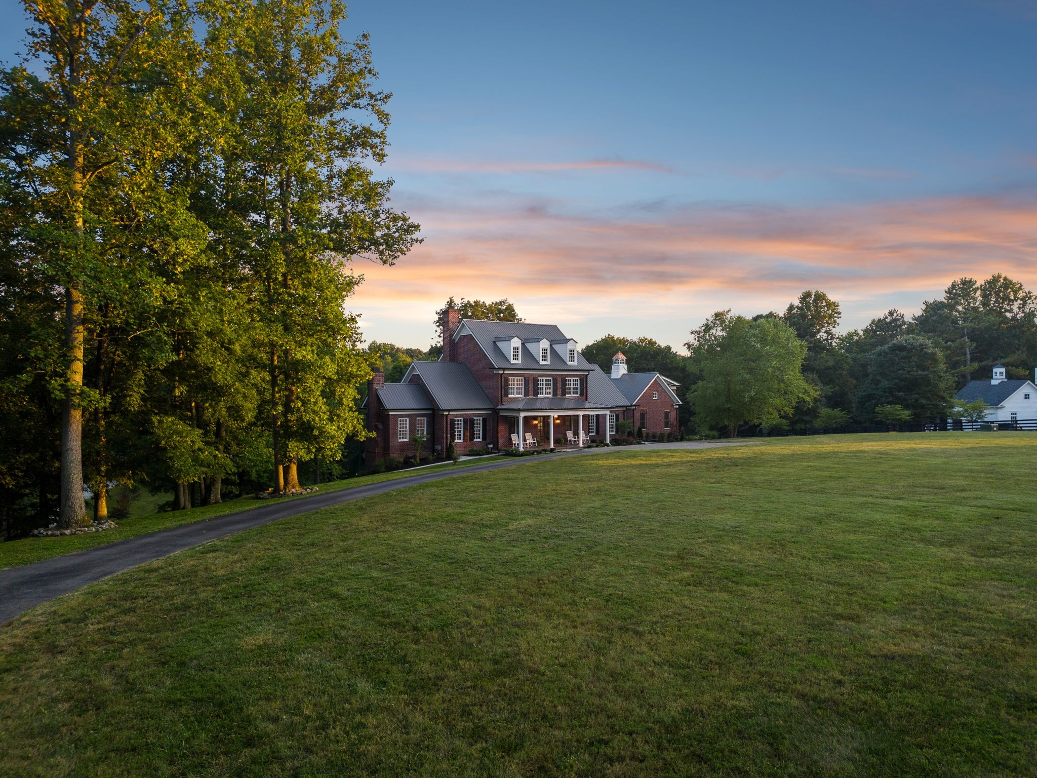 a view of a big yard with a house in the background