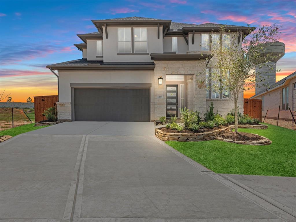 a front view of a house with yard and green space