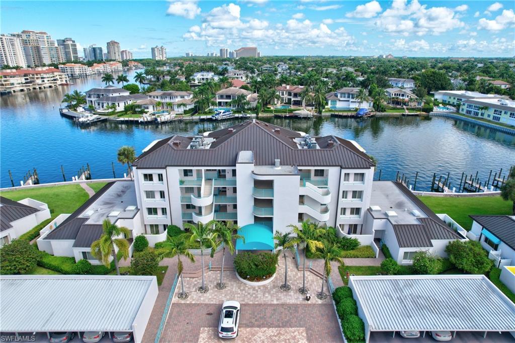 an aerial view of a house with a garden and lake view