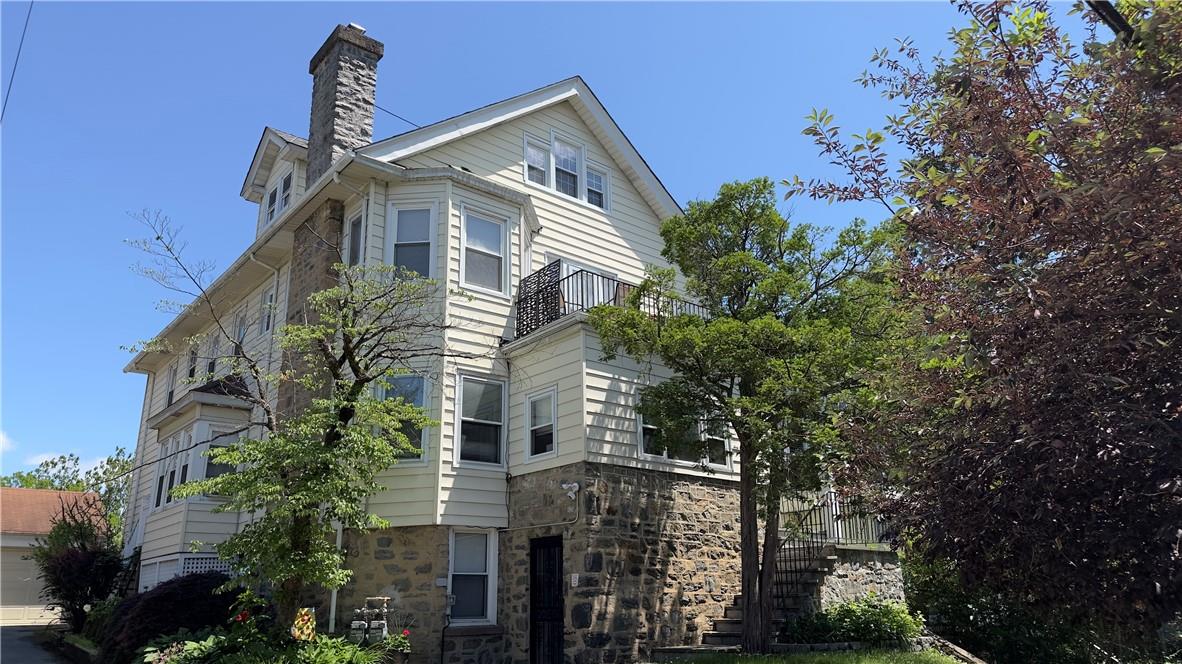 a view of a house with a tree