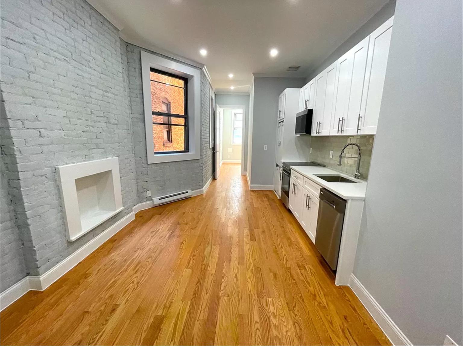 a view of kitchen with wooden floor electronic appliances and window