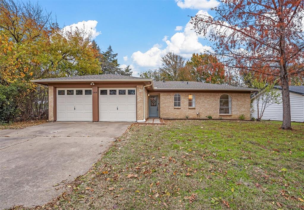 a view of a house with a yard and garage