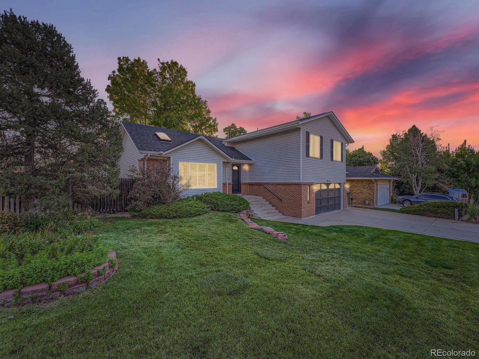 a view of a house with a yard and sitting area