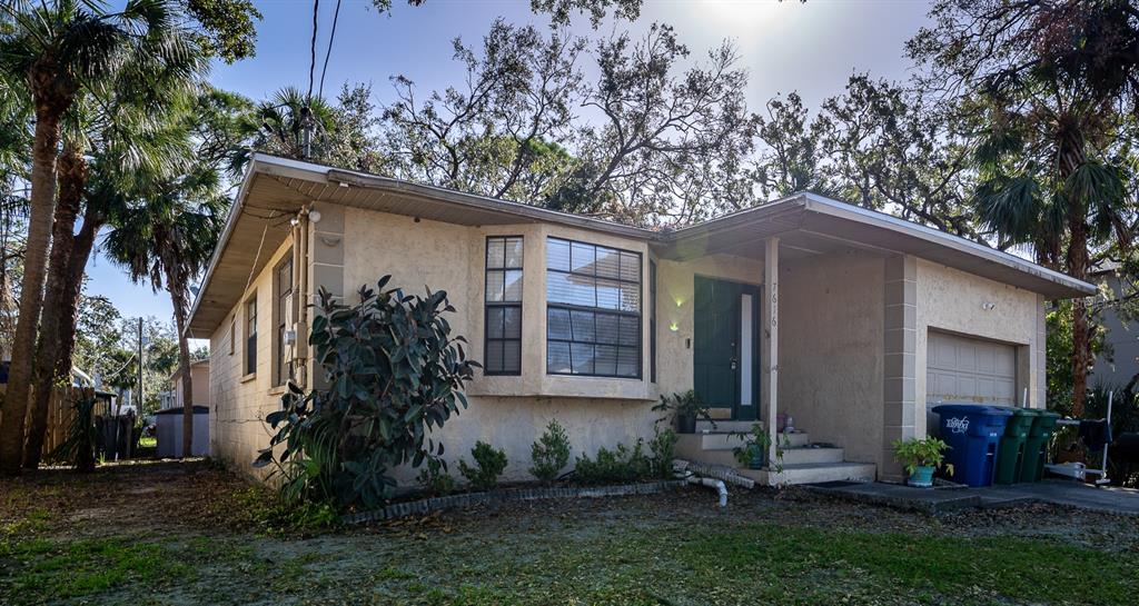 a view of a house with a yard and tree s