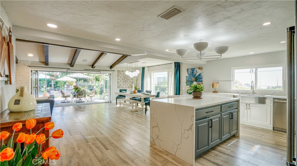 a kitchen with a stove and a view of living room