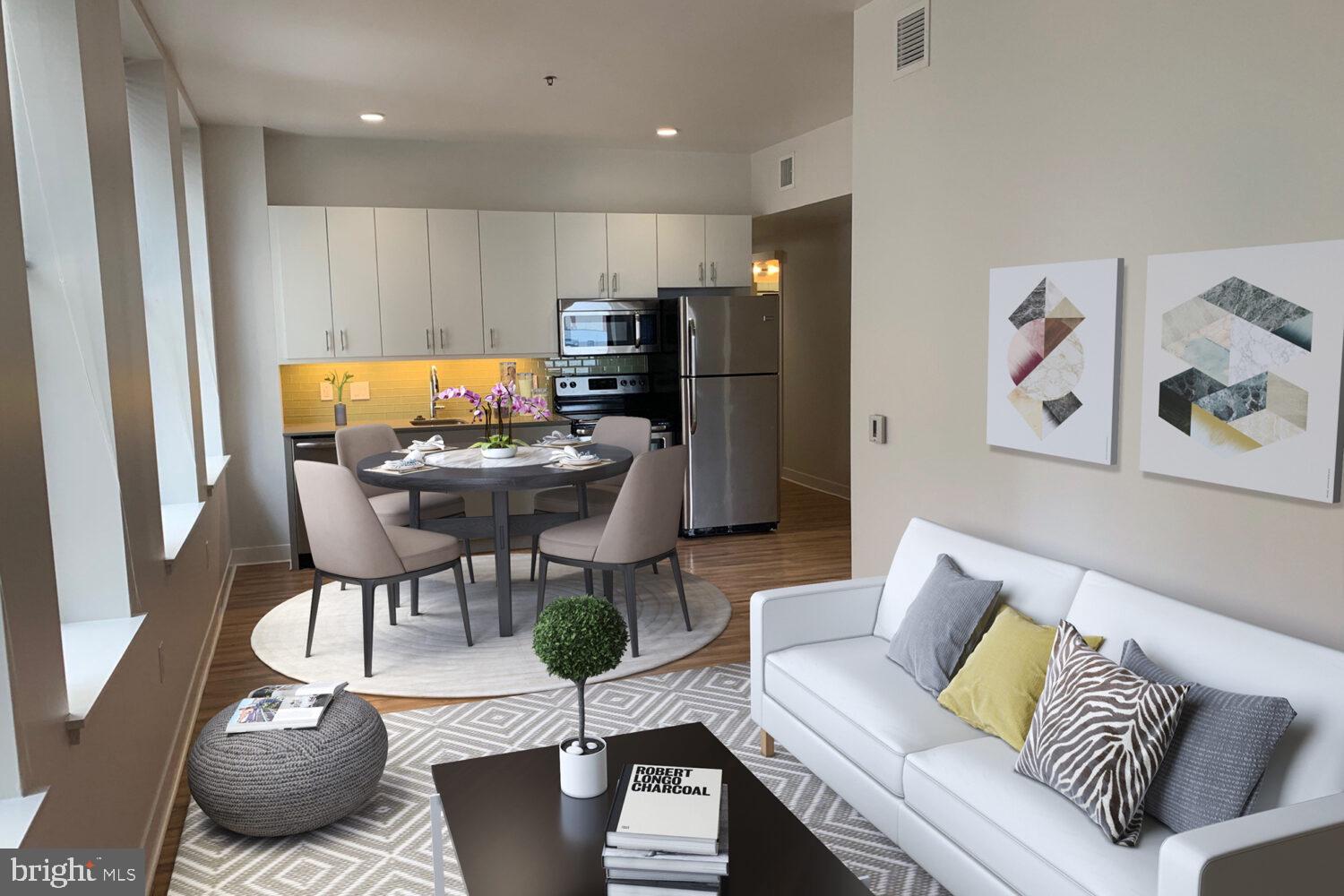 a living room with furniture and kitchen view