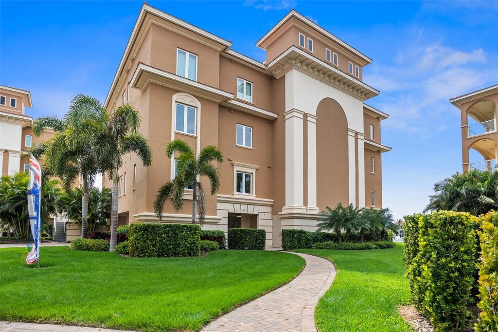 Front elevation showing first level Garage with three condominiums above.  Over 3,800 sq. ft, 4 Bdr, 4.5 Bath with almost 1,000 sq.ft. of covered terrace overlooking Boca Ciega Bay.  Private garage for two vehicles on first level.