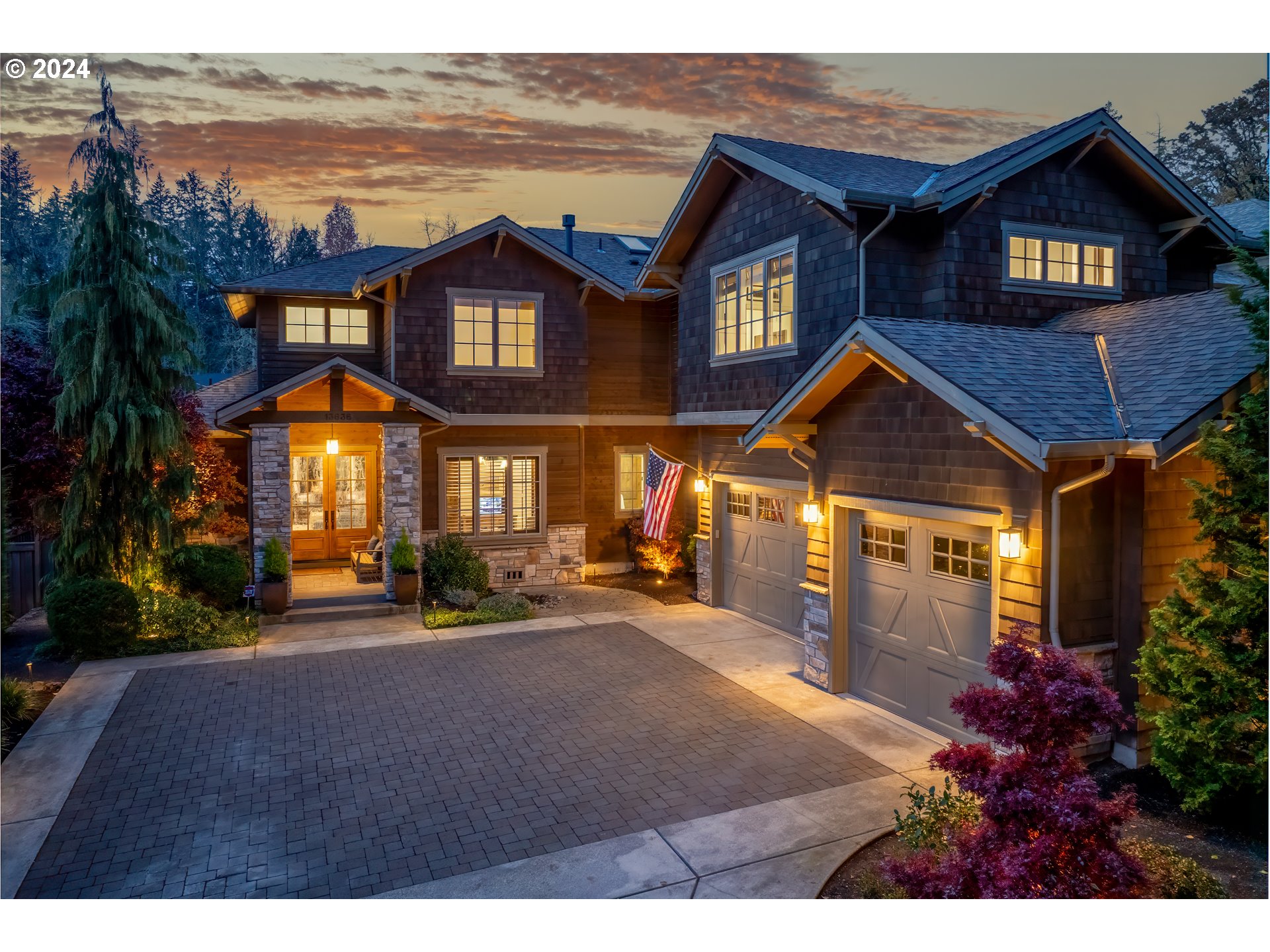 a front view of a house with a yard lake and outdoor seating