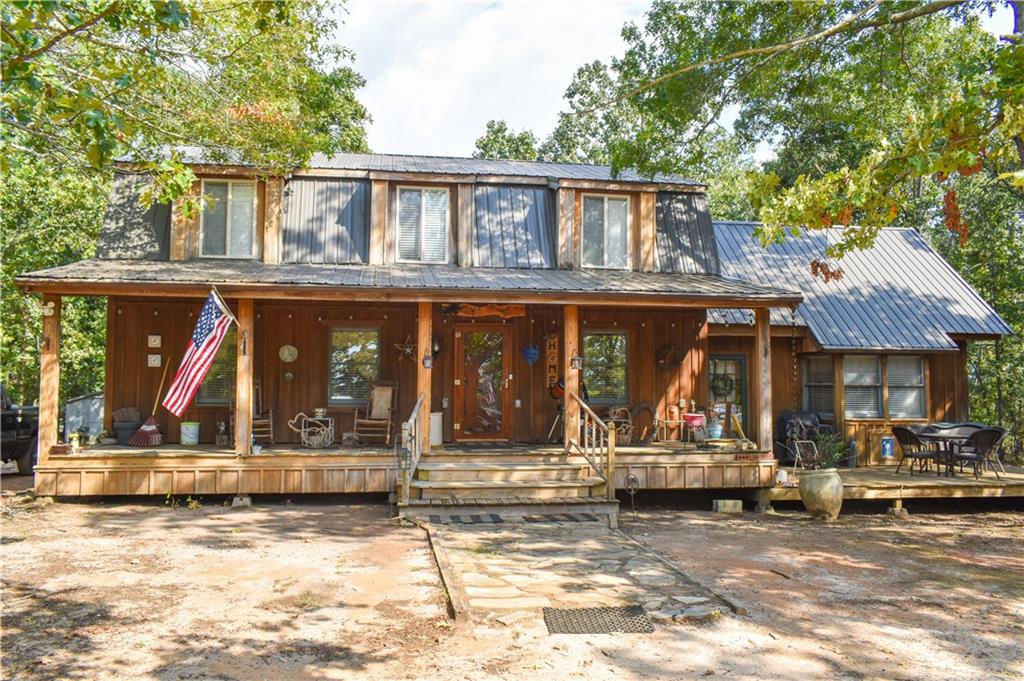 The main house features a covered porch and deck and custom storm door.