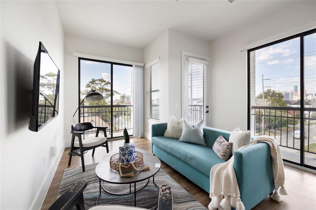 a living room with furniture and a large window