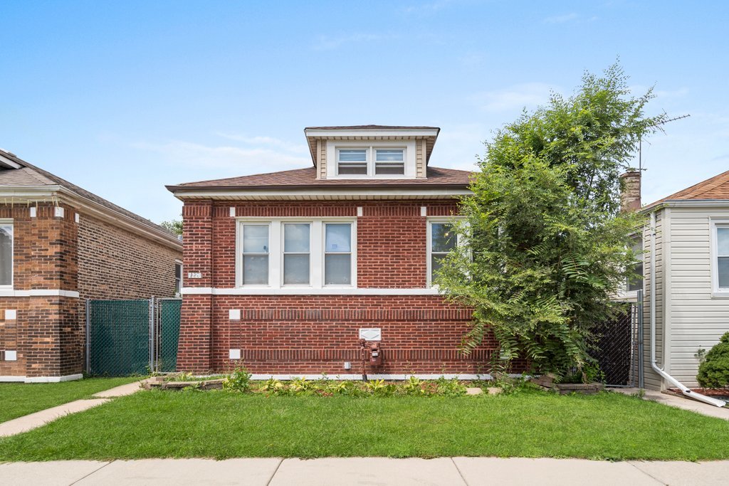 front view of a house with a yard