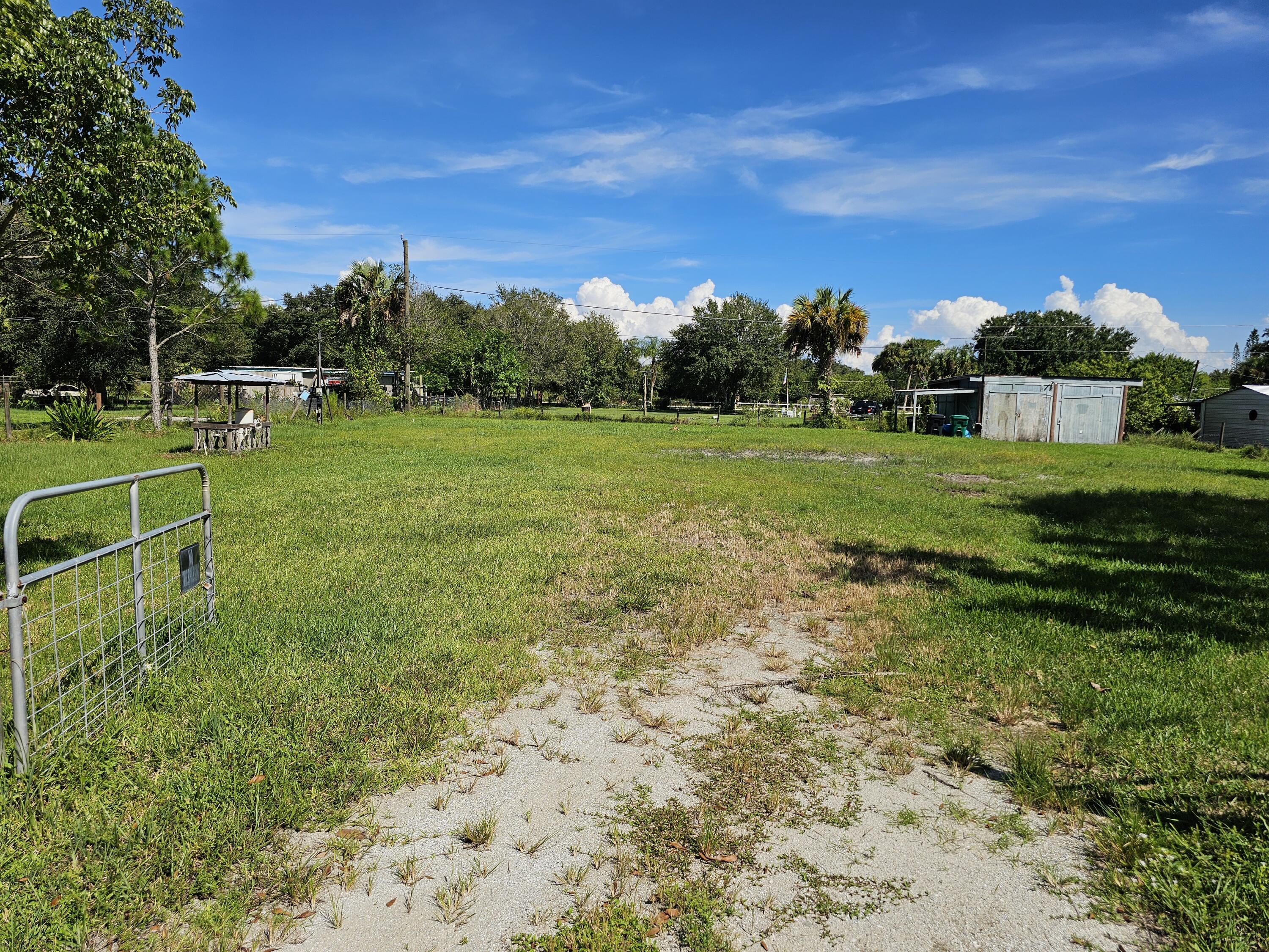 a view of a field with grass and a houses