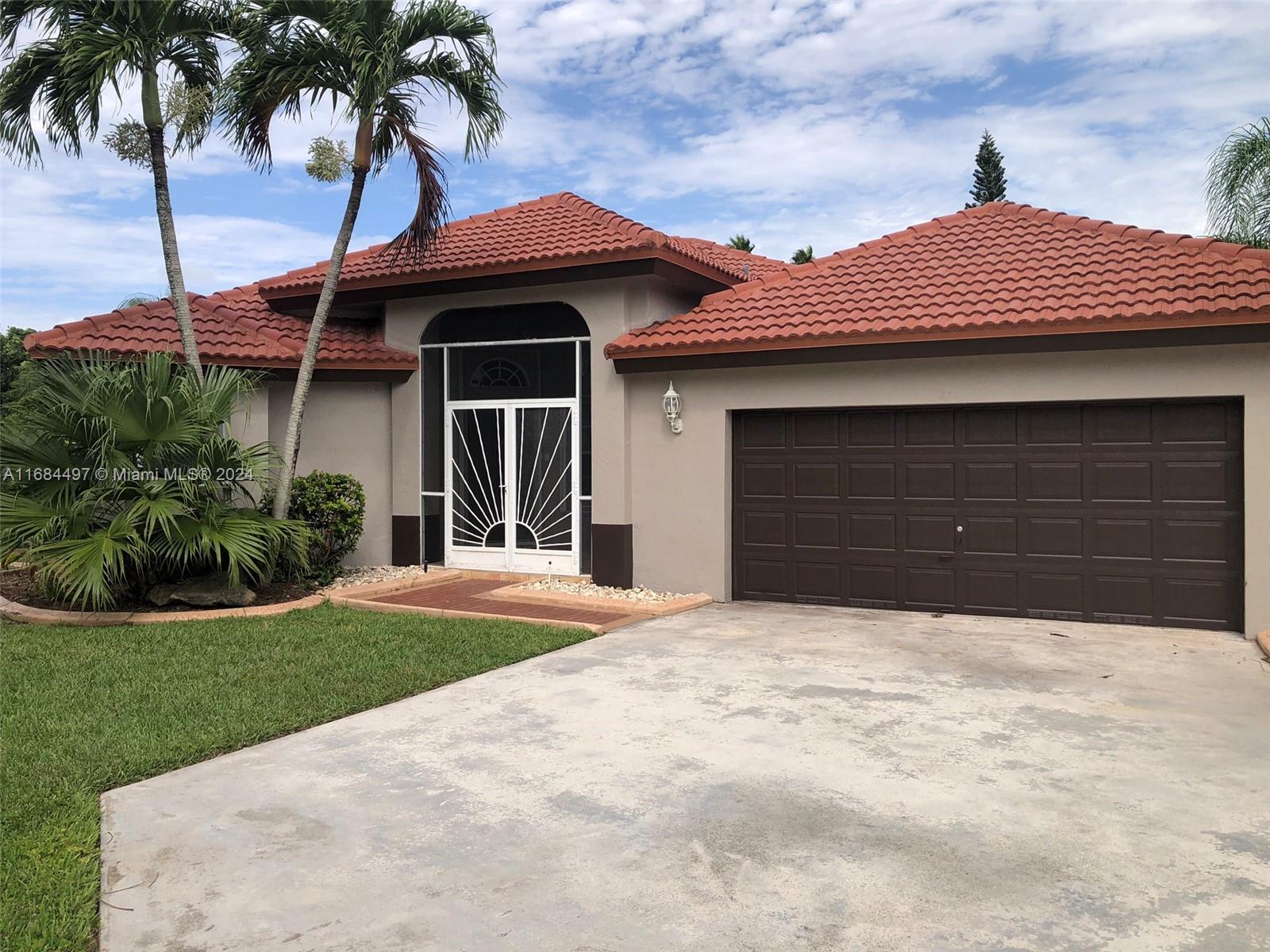 a front view of a house with garage