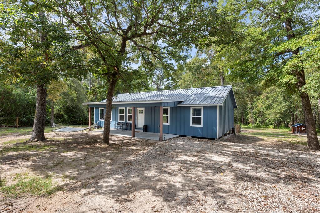 a house that has a tree in front of it