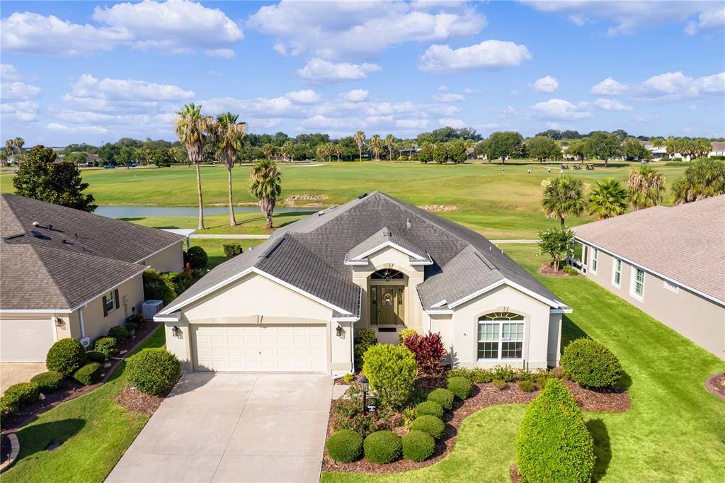 a aerial view of a house with a garden and lake view