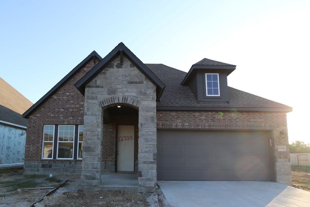 a front view of a house with a garage