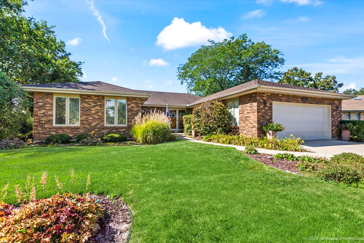 a front view of house with yard and green space