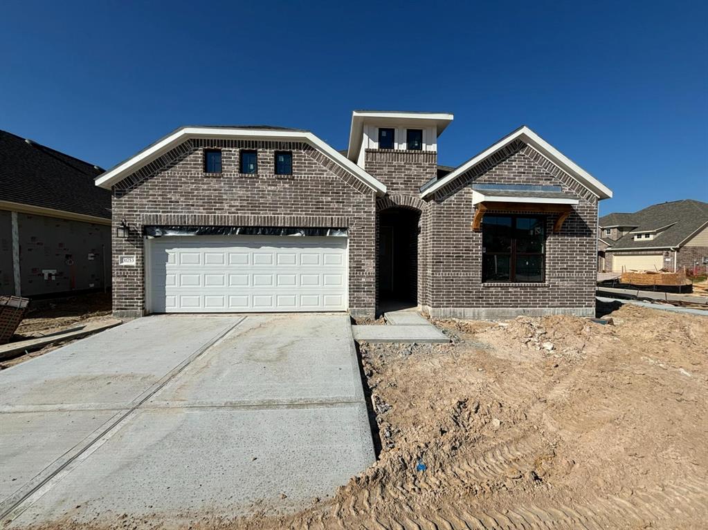 a front view of a house with parking garage and garage