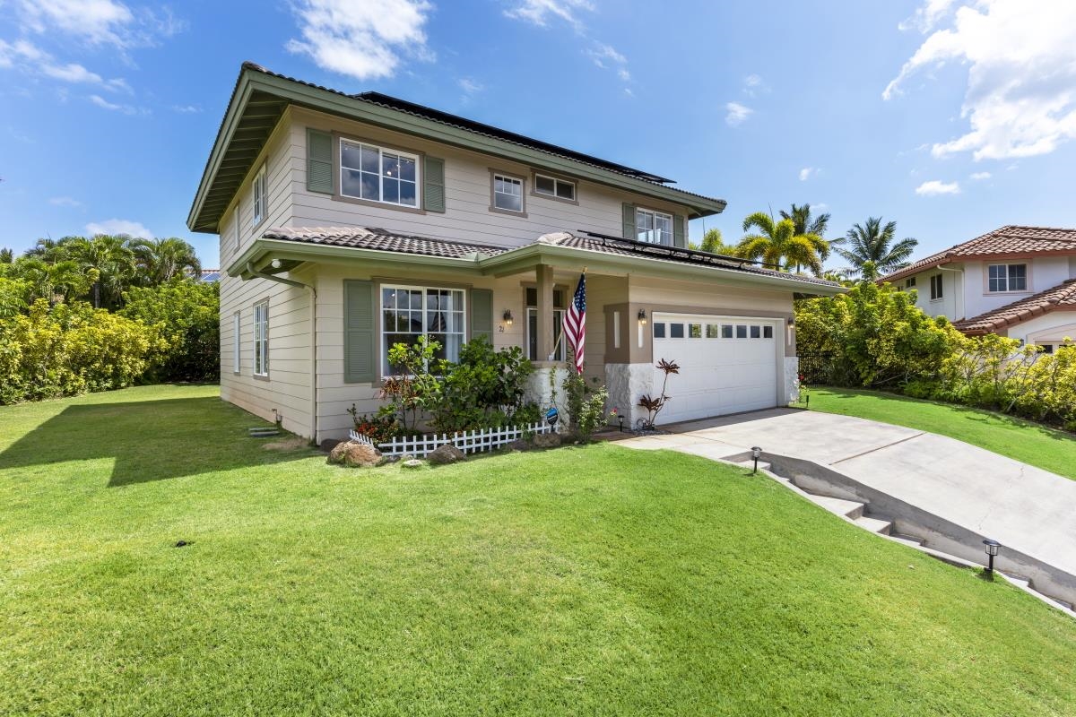 a front view of a house with a yard and garage