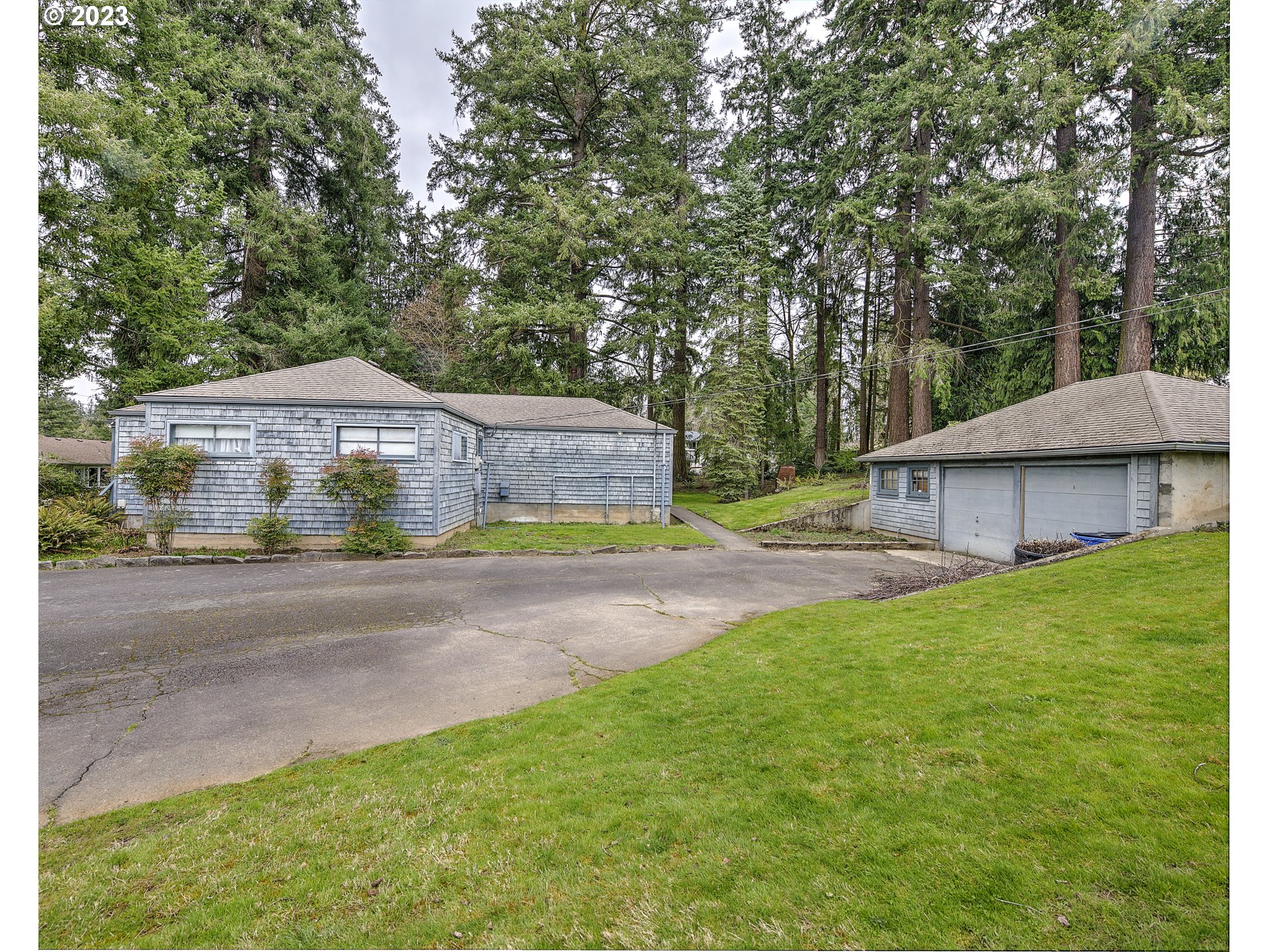 a front view of house with yard and outdoor seating