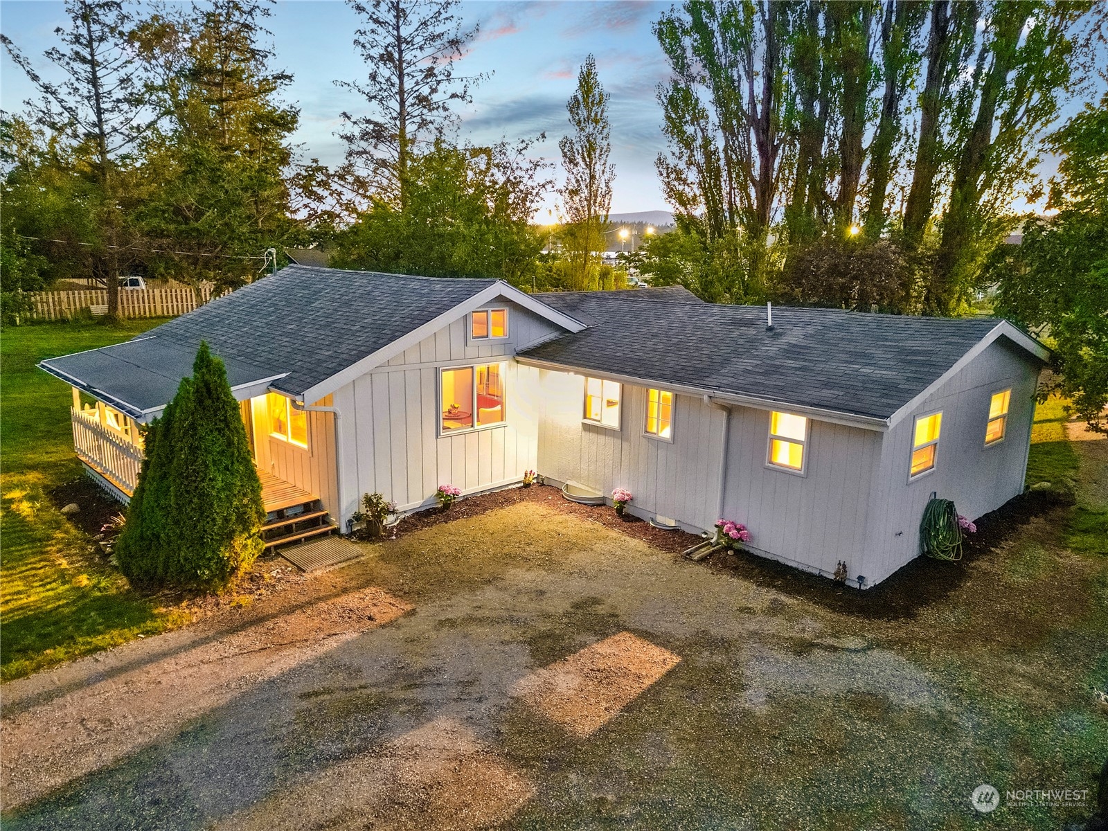 a view of a house with a yard and tree s