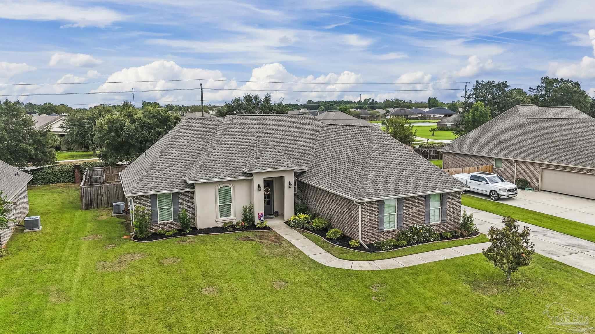 a aerial view of a house with a yard table and chairs