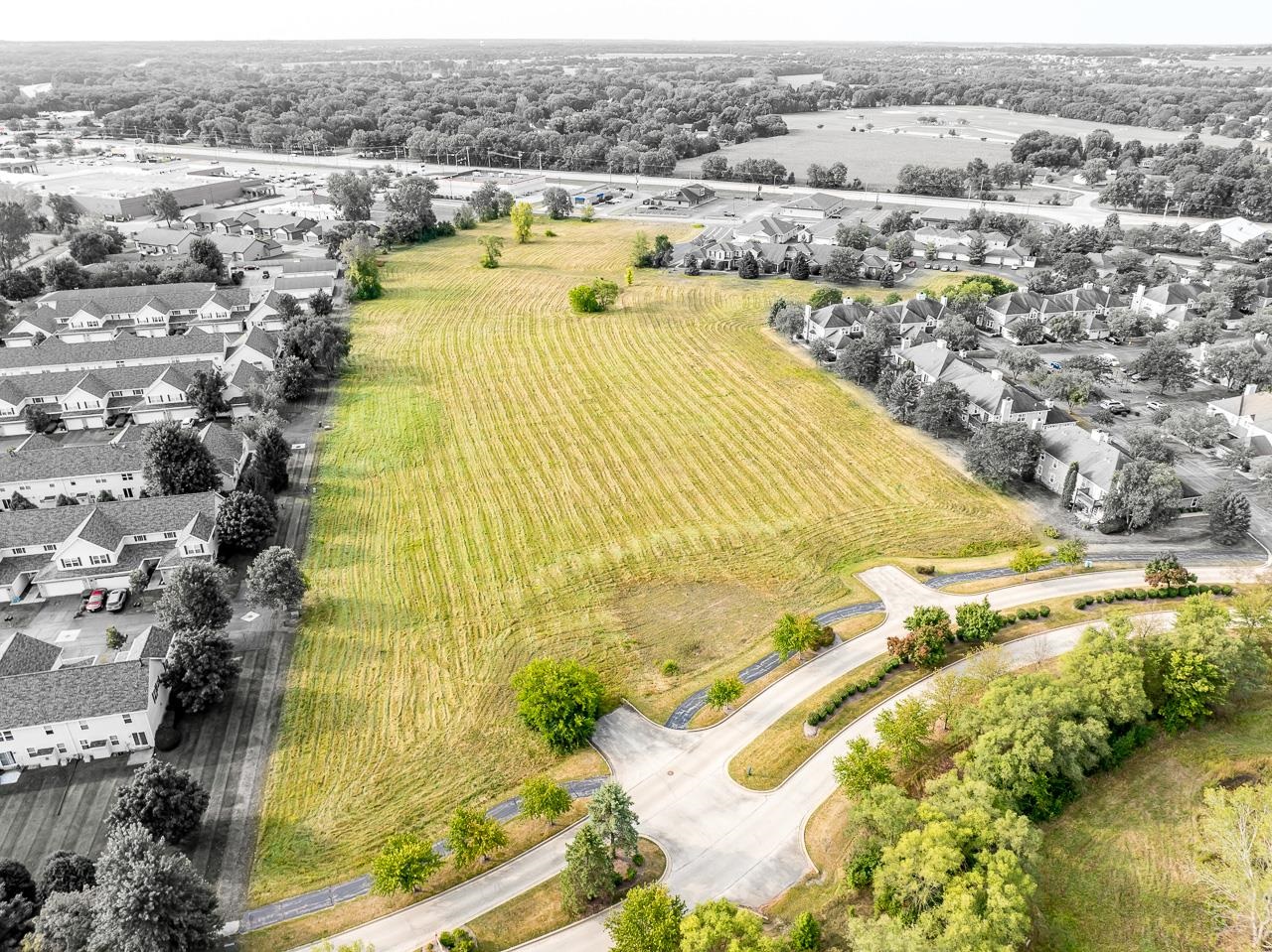 an aerial view of residential houses with outdoor space