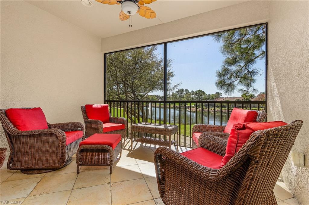 a living room with furniture and a floor to ceiling window