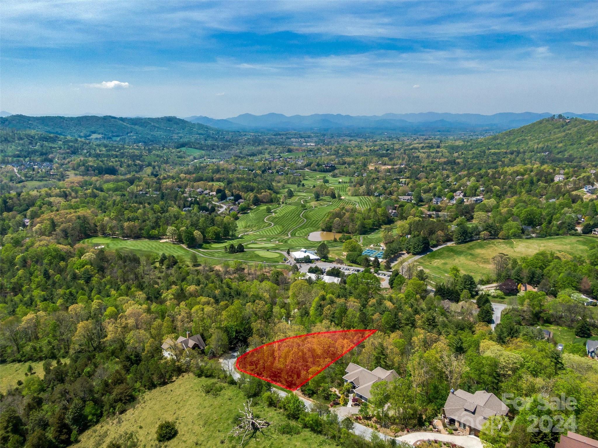 an aerial view of a houses with a yard