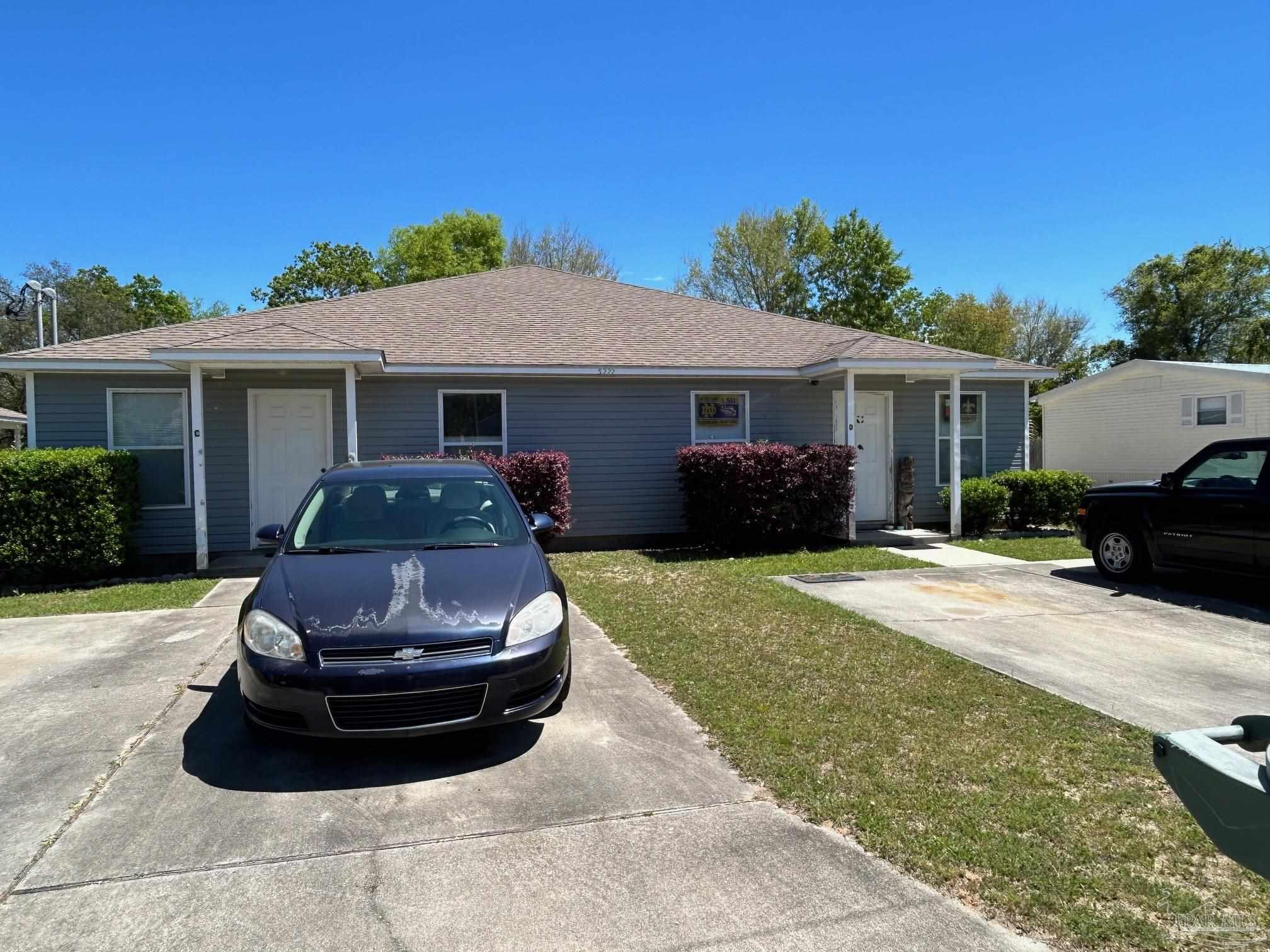 a front view of house with yard and outdoor seating